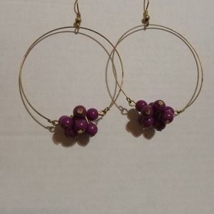 Hoop earrings with purple beating on the bottom